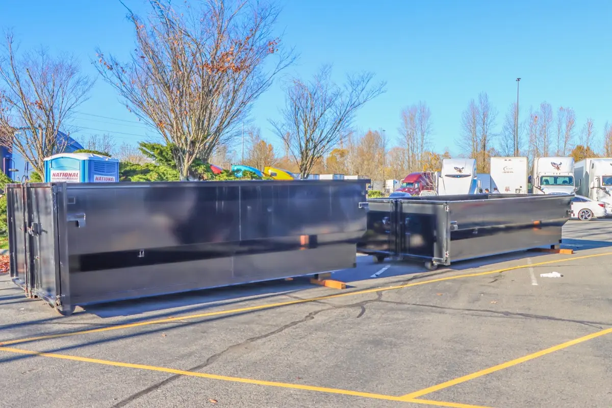 Professional dumpster rental service with roll-off container on residential driveway in Signal Mountain